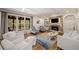 Bright living room boasts coffered ceilings, a stone fireplace, and a sunroom with wooded views at 407 Maple Ridge Ct, Cumming, GA 30028