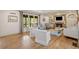 Beautiful living room with hardwood floors, a fireplace, and a sunroom with wooded views at 407 Maple Ridge Ct, Cumming, GA 30028