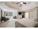 Spacious main bedroom with tray ceilings, sitting area, and a large en-suite bathroom at 407 Maple Ridge Ct, Cumming, GA 30028