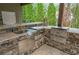 Modern outdoor kitchen with stone counters, stainless steel appliances, and ample storage at 407 Maple Ridge Ct, Cumming, GA 30028