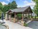 A fully-equipped outdoor kitchen with stone accents, a bar, a dining area, and a pool, perfect for entertaining at 407 Maple Ridge Ct, Cumming, GA 30028