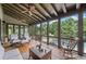 Relaxing screened-in porch features comfortable seating with views of the pool and lush landscaping at 407 Maple Ridge Ct, Cumming, GA 30028