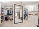 Organized walk-in closet with custom shelving, ample hanging space, and full-length mirror at 407 Maple Ridge Ct, Cumming, GA 30028