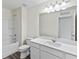 Bright bathroom featuring a tub-shower combo, white cabinets, and plank flooring at 1221 Fagiolo St, Mcdonough, GA 30253