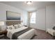 This bedroom features neutral colors, a queen size bed, and a window with natural light at 1221 Fagiolo St, Mcdonough, GA 30253