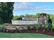 Stone signage welcomes residents to the Kendall Grove community amidst a lush, green landscape at 1221 Fagiolo St, Mcdonough, GA 30253