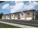 Newly constructed townhomes feature brick exteriors, two-car garages, and professionally landscaped surroundings at 1221 Fagiolo St, Mcdonough, GA 30253