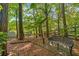 Tranquil backyard setting featuring a hammock and a wrought iron bench at 1945 Barrett Dr, Cumming, GA 30040