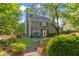 Exterior of home with landscaped yard, featuring a patio and garden at 1945 Barrett Dr, Cumming, GA 30040