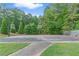 Outdoor basketball court with two hoops, picnic tables, and surrounding green space at 1945 Barrett Dr, Cumming, GA 30040