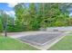 Outdoor basketball court with multiple hoops, seating, and surrounding green space at 1945 Barrett Dr, Cumming, GA 30040