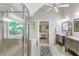 Bathroom featuring a walk-in shower, soaking tub, dual vanities, and a glimpse into the spacious main bedroom at 1945 Barrett Dr, Cumming, GA 30040
