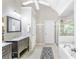 Bright bathroom featuring a walk-in shower, soaking tub, modern vanity, tile floors, and white fixtures at 1945 Barrett Dr, Cumming, GA 30040