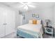 Bedroom featuring light gray walls, double closets, a window, and a ceiling fan at 1945 Barrett Dr, Cumming, GA 30040