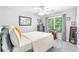 Bedroom featuring a neutral color palette, natural light, dresser, and decorative accents at 1945 Barrett Dr, Cumming, GA 30040