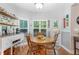 Cozy breakfast nook featuring a round wooden table with a view of the backyard at 1945 Barrett Dr, Cumming, GA 30040