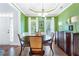 Elegant dining room featuring hardwood floors, soft lighting, and a decorative tray ceiling at 1945 Barrett Dr, Cumming, GA 30040
