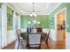 Bright dining room featuring hardwood floors, soft lighting, and kitchen access at 1945 Barrett Dr, Cumming, GA 30040