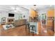 Open kitchen with a breakfast bar, granite countertops, mosaic tile backsplash, and wood cabinets at 1945 Barrett Dr, Cumming, GA 30040