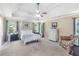 Spacious main bedroom with trey ceiling, fan, neutral color palette, and large windows bringing in natural light at 1945 Barrett Dr, Cumming, GA 30040