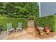 Charming patio with chairs, leading to a garden gate with lush greenery and bird bath at 1945 Barrett Dr, Cumming, GA 30040