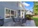Outdoor patio area with a table and chairs, ideal for relaxation and entertaining at 1945 Barrett Dr, Cumming, GA 30040