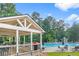 Community pool area with covered seating and lounge chairs surrounded by trees at 1945 Barrett Dr, Cumming, GA 30040