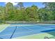 Well-maintained tennis court with net and surrounding green space at 1945 Barrett Dr, Cumming, GA 30040
