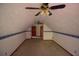 Cozy attic space featuring a ceiling fan, carpet, and unique architectural details at 20 Lisa Ct, Stockbridge, GA 30281