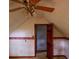 Carpeted attic space featuring a ceiling fan and unique architectural details at 20 Lisa Ct, Stockbridge, GA 30281
