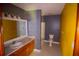 Bathroom featuring a spacious vanity, with a mirror, toilet and yellow wall at 20 Lisa Ct, Stockbridge, GA 30281