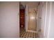Hallway view of a bathroom featuring patterned floors, a mirror, and shower at 20 Lisa Ct, Stockbridge, GA 30281