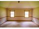 Carpeted Primary bedroom features two windows and decorative chair-rail molding at 20 Lisa Ct, Stockbridge, GA 30281