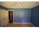 Bedroom features neutral carpet, blue walls, and white trim at 20 Lisa Ct, Stockbridge, GA 30281