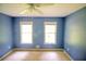 Bedroom features neutral carpet, blue walls, and windows at 20 Lisa Ct, Stockbridge, GA 30281