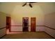 Open bedroom with a fan and trim and multiple doorways into other rooms at 20 Lisa Ct, Stockbridge, GA 30281