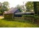 Quaint house with a covered porch and a lush, green yard surrounded by mature trees at 20 Lisa Ct, Stockbridge, GA 30281