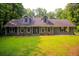Charming single-Gathering home featuring stone accents, a dormered roof, and a well-maintained front yard at 20 Lisa Ct, Stockbridge, GA 30281