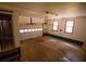 Garage featuring empty floors, a partially open garage door, and a small window at 20 Lisa Ct, Stockbridge, GA 30281