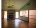 Spacious living room featuring a stone fireplace, a ceiling fan, wood-look flooring, and natural light at 20 Lisa Ct, Stockbridge, GA 30281