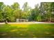 Picturesque view of a house across a well-maintained lawn in a peaceful, wooded neighborhood at 20 Lisa Ct, Stockbridge, GA 30281