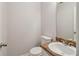 Charming half bathroom with a stylish vanity and toilet, perfect for guests at 310 Wolf Downs Way, Atlanta, GA 30349