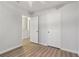This bedroom features laminate flooring, neutral walls, and two door access at 310 Wolf Downs Way, Atlanta, GA 30349
