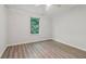 A bedroom with laminate wood floors, a window, and a ceiling fan with lights at 310 Wolf Downs Way, Atlanta, GA 30349