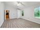Bright bedroom featuring light walls, laminate floors, and a ceiling fan at 310 Wolf Downs Way, Atlanta, GA 30349
