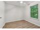 Bright bedroom with hardwood floors, a ceiling fan, and natural light from the window at 310 Wolf Downs Way, Atlanta, GA 30349