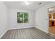 Bright dining area with modern flooring and a window overlooking lush greenery at 310 Wolf Downs Way, Atlanta, GA 30349