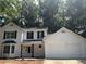 Charming two-story home with a two-car garage and mature trees, all in a desirable neighborhood at 310 Wolf Downs Way, Atlanta, GA 30349