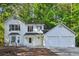 Charming two-story home with a two car garage and bay window, nestled in a lush green environment at 310 Wolf Downs Way, Atlanta, GA 30349