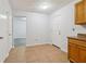 Traditional kitchen with tile floors, white walls, and natural wood cabinets at 310 Wolf Downs Way, Atlanta, GA 30349